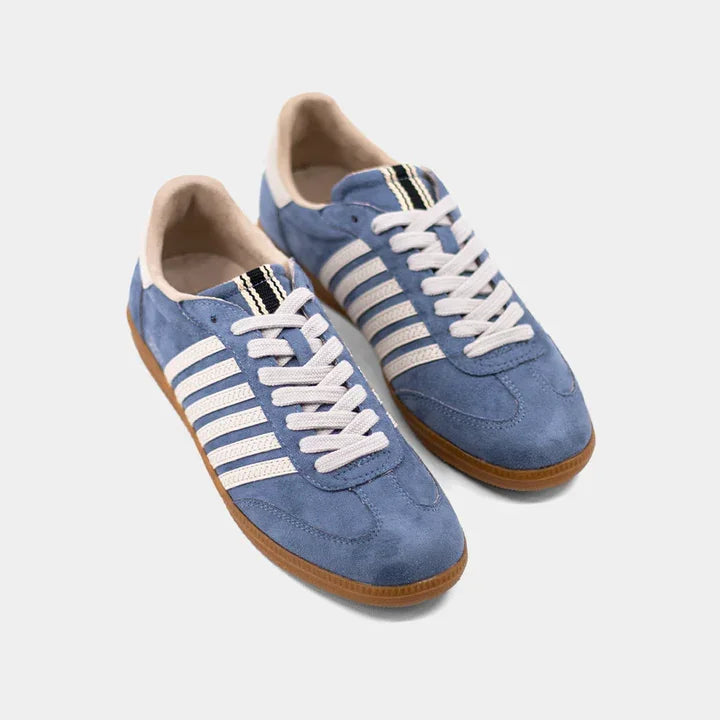 Blue suede tennis shoes with white-beige stripes and gum sole, perfect for coastal boutique clothing and stylish women's fashion.