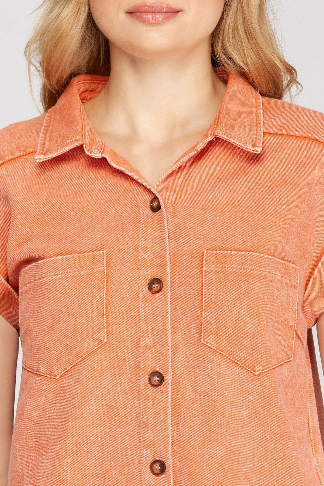 Model wearing the KEEP IT COOL DRESS in orange from Raggdoll Boutique, showcasing trendy coastal style.