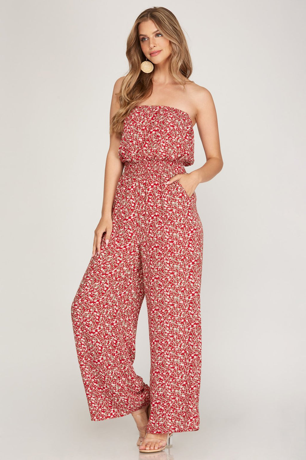 Stylish woman wearing a RED FLORAL STRAPLESS JUMPSUIT from Raggdoll Boutique, perfect for summer outfits Texas.