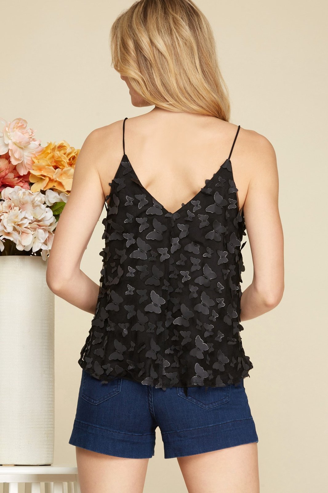 Back view of BLACK BUTTERFLY APPLIQUE TOP paired with shorts at Raggdoll Boutique in Port Aransas, coastal fashion.