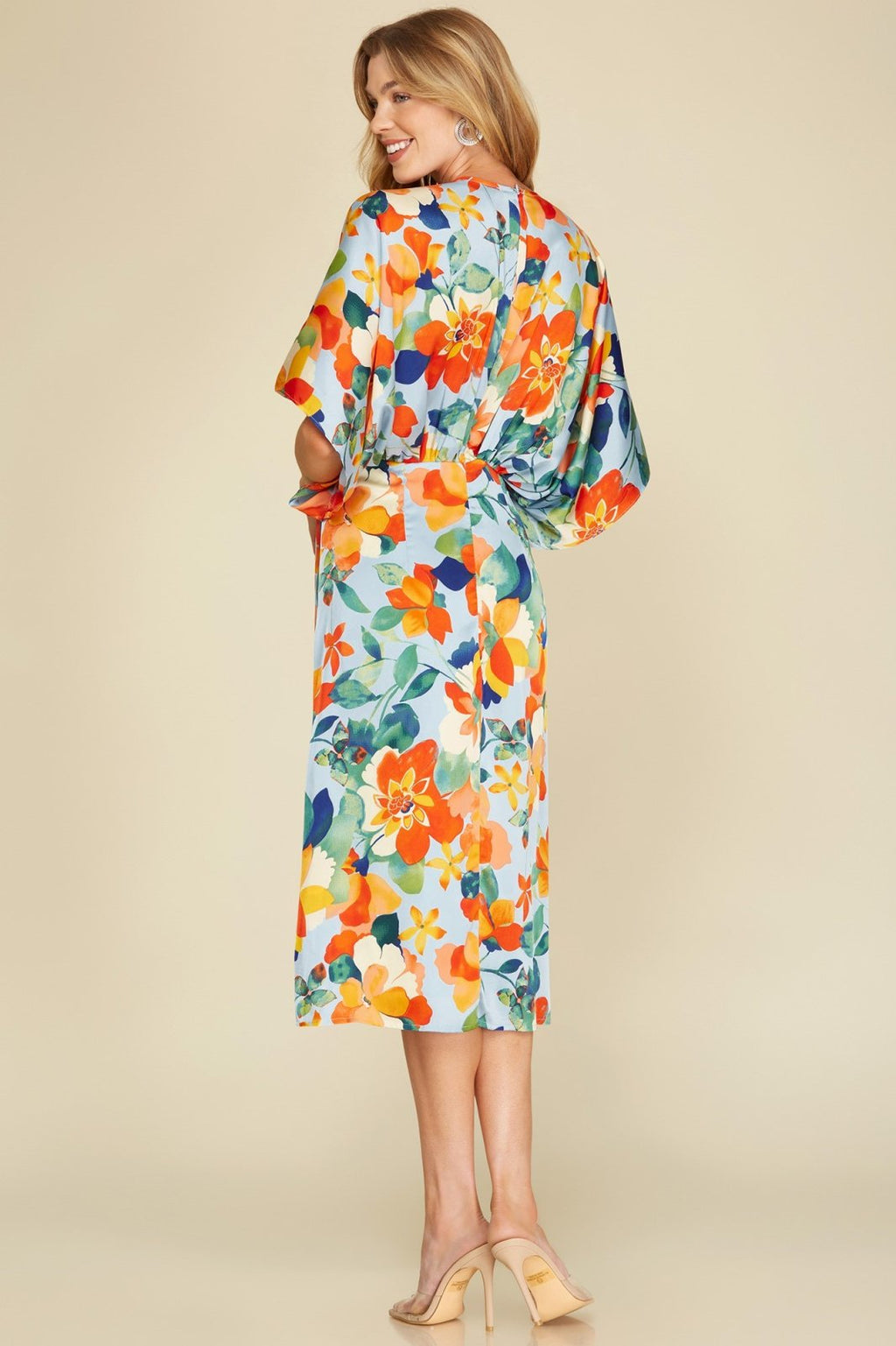 DOSE OF DRAMA DRESS displayed on a model, showcasing vibrant floral patterns, perfect for coastal fashion at Raggdoll Boutique.