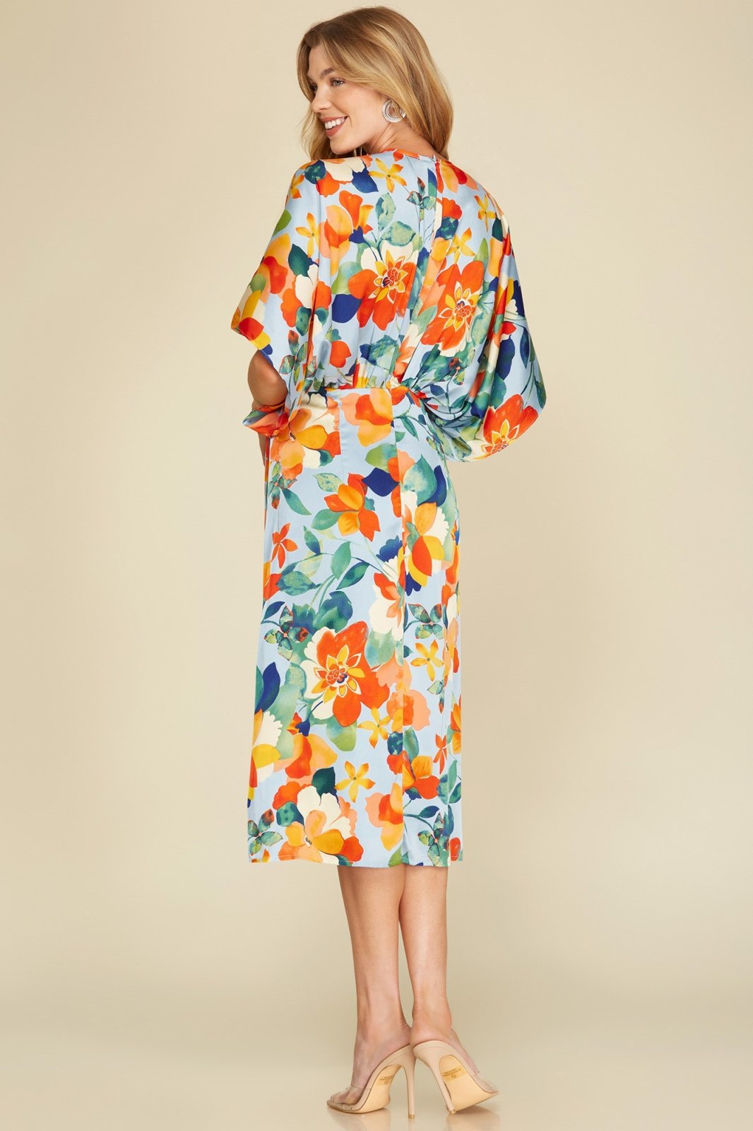 DOSE OF DRAMA DRESS displayed on a model, showcasing vibrant floral patterns, perfect for coastal fashion at Raggdoll Boutique.