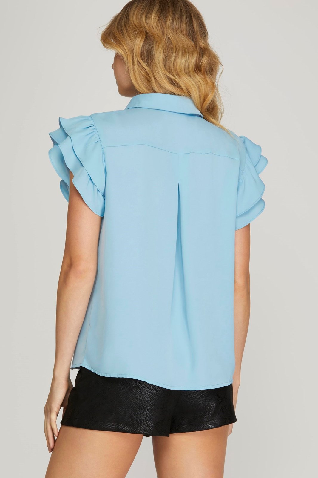 Sky blue flutter sleeve top for women, stylish and breathable, perfect for coastal boutique clothing and tropical vacations.