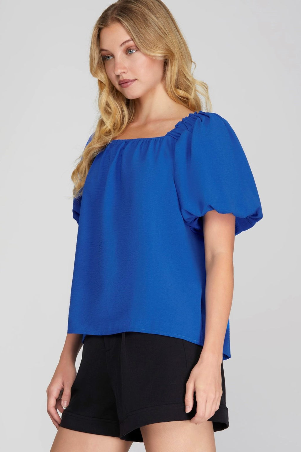 Dani Top in blue worn with black shorts, ideal for summer outfits Texas from Raggdoll Boutique.