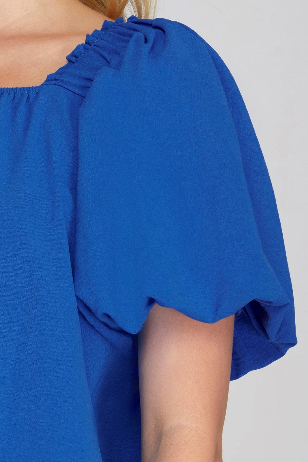 Dani Top in vibrant blue with stylish puff sleeves from Raggdoll Boutique, perfect for summer outfits Texas.
