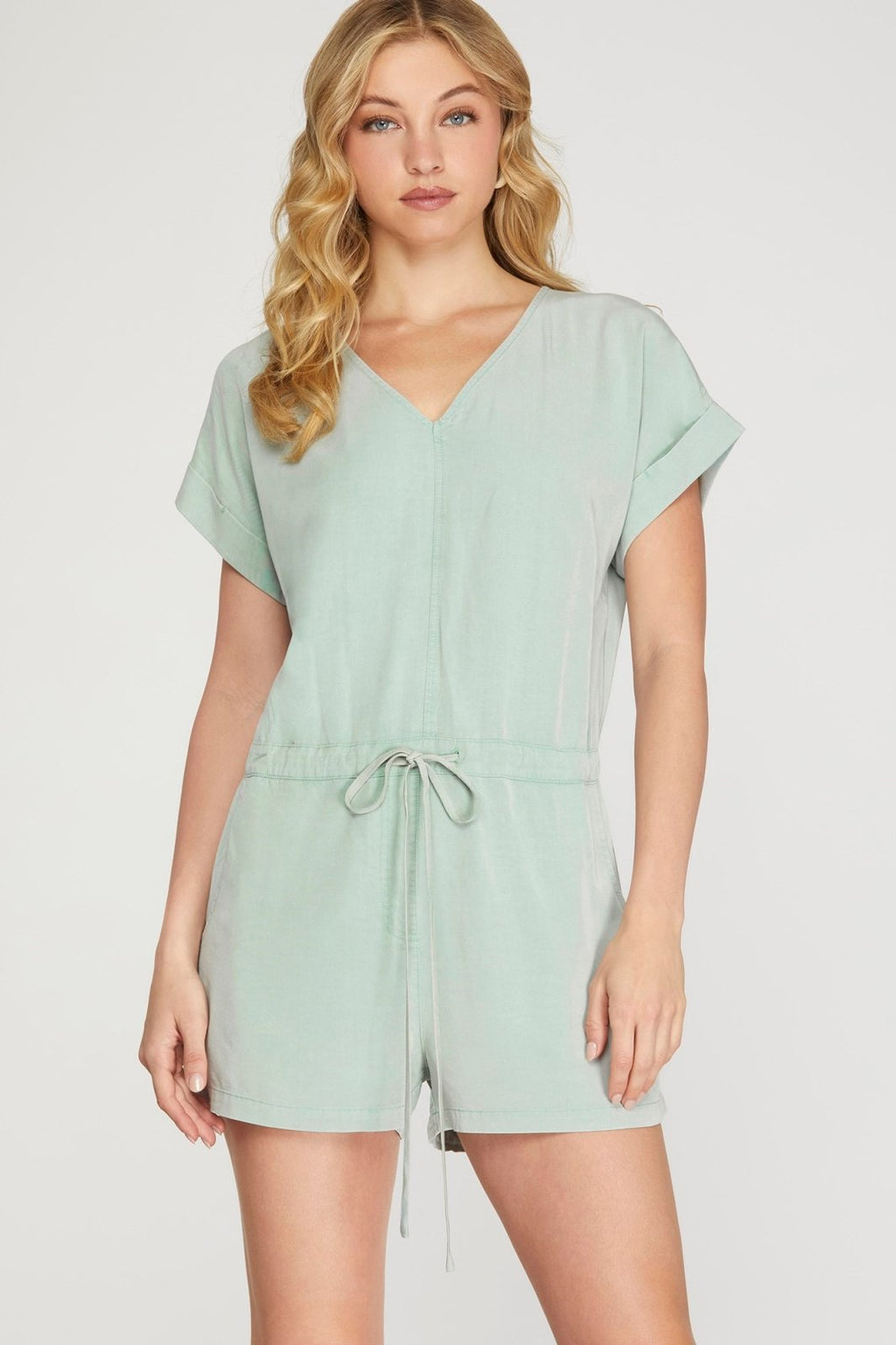 Stylish seafoam tie-back romper from a coastal boutique, perfect for beach days and casual outings. Part of curated women's fashion.