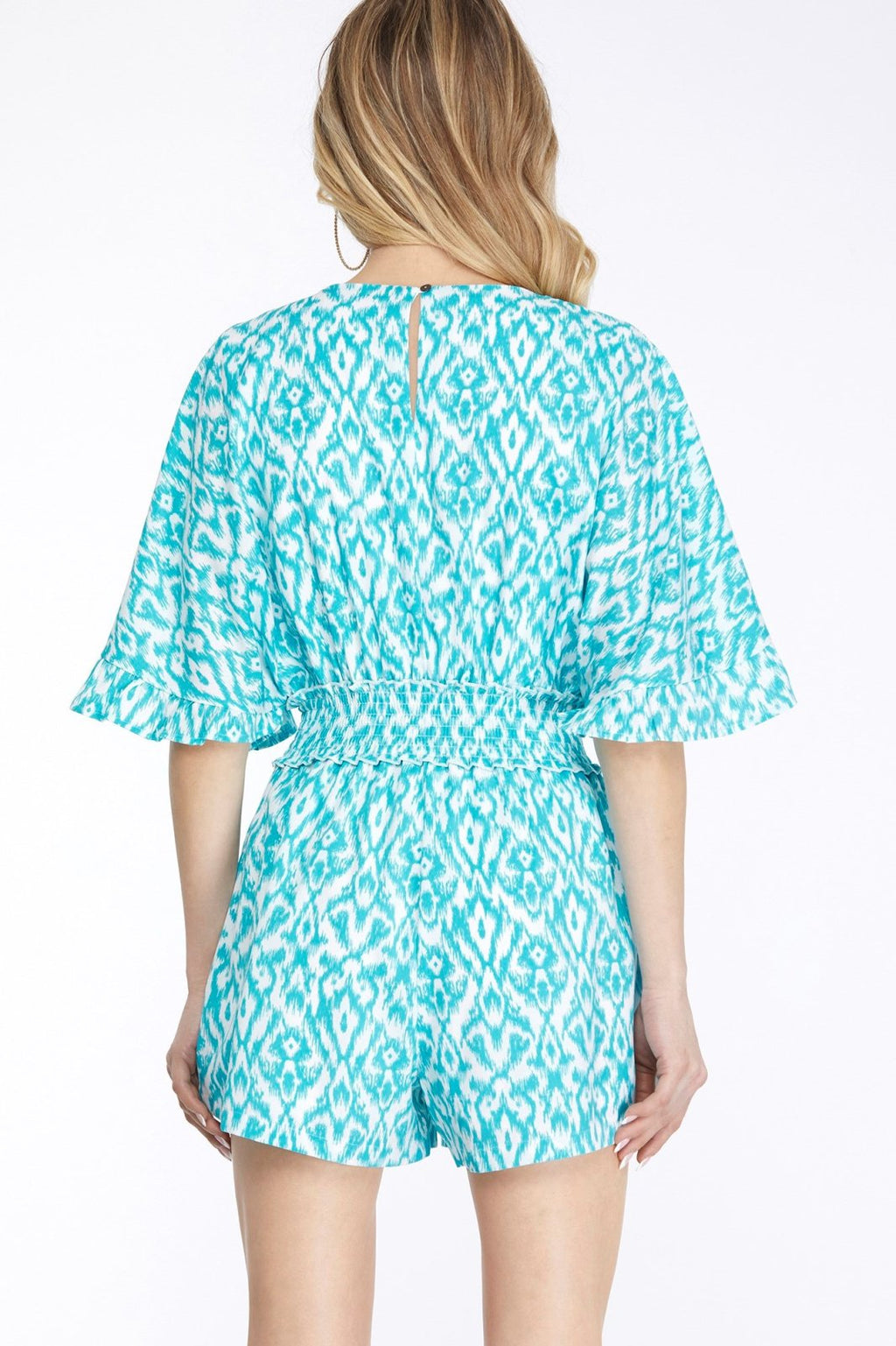 Aqua and White Smocked V-Neck Romper displayed from the back, perfect for trendy coastal style at Raggdoll Boutique.