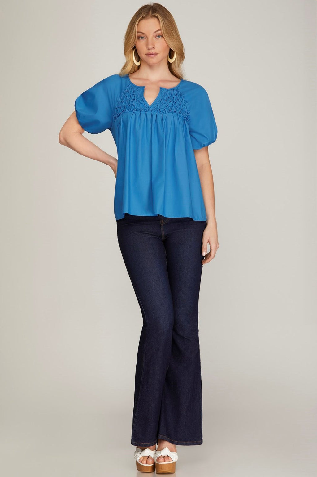 Model wearing a Blue Textured Poplin Top with flared jeans, showcasing trendy coastal style from Raggdoll Boutique.