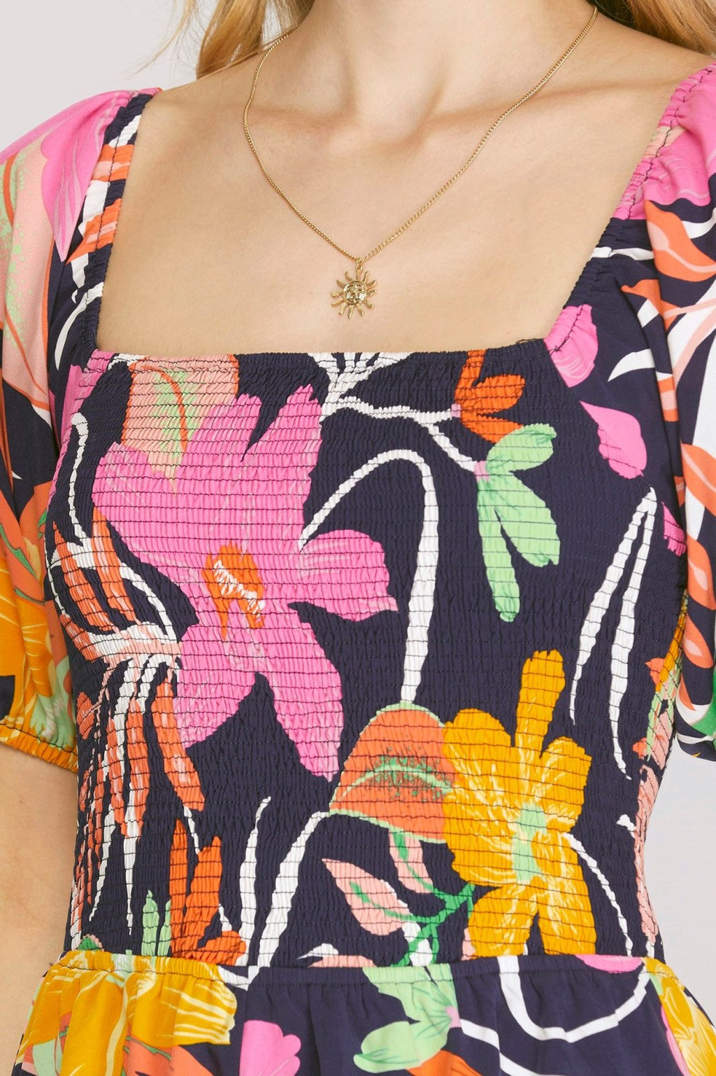 Navy with Tropical Print Romper featuring colorful floral design and square neckline from Raggdoll Boutique.
