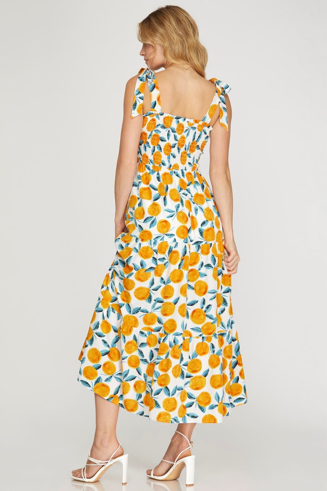 Back view of the Orange You in Love Dress!! featuring a citrus print and shoulder ties, perfect for summer outfits Texas.