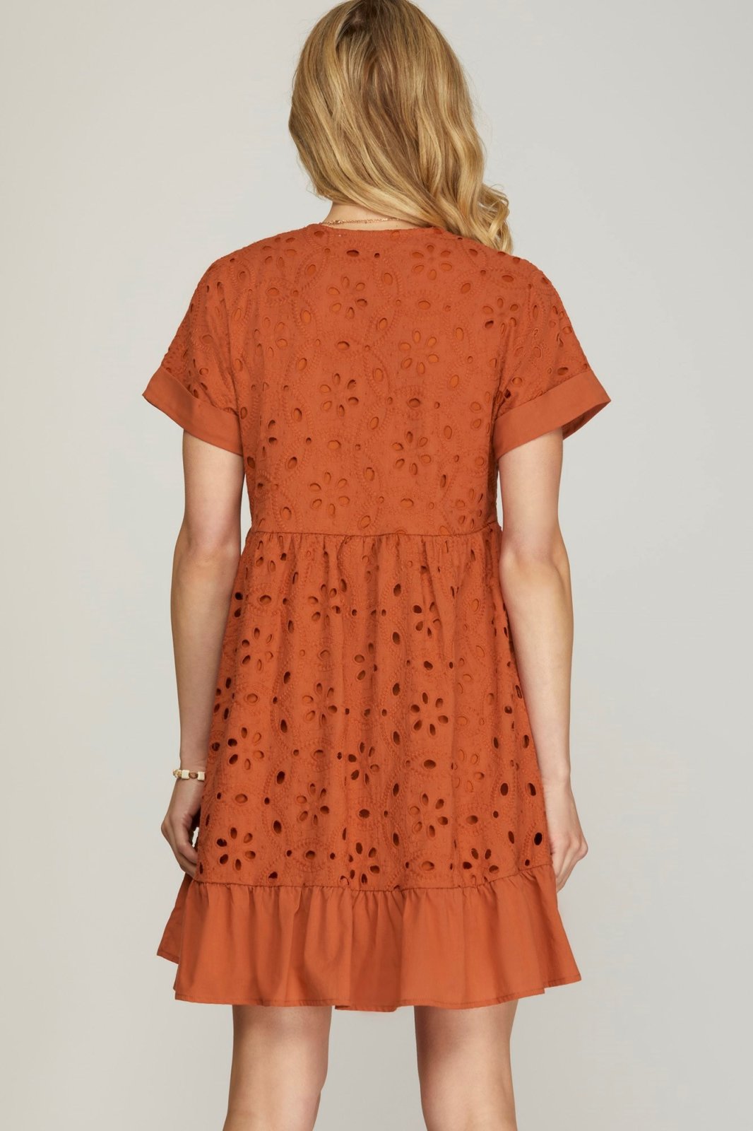 Rust-colored embroidered dress from a Port Aransas boutique, perfect for coastal fashion and tropical vacations.