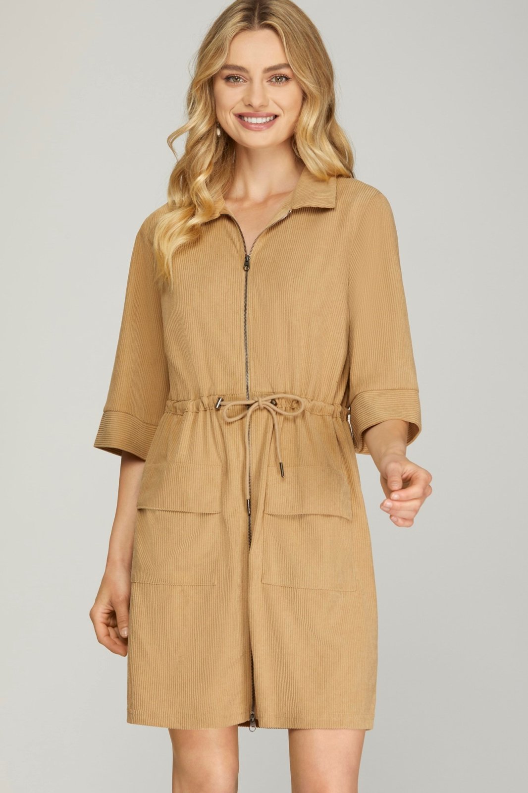 Casey Dress: Stylish beige zip-up dress with pockets, perfect for coastal boutique clothing and tropical vacations.