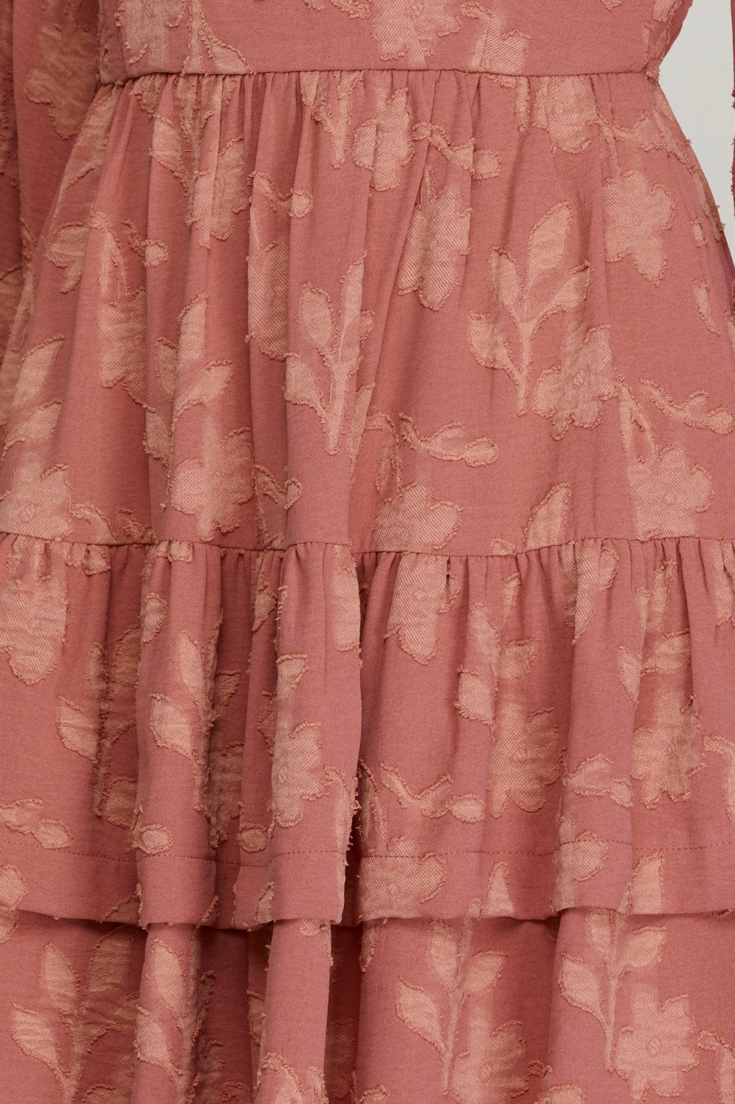 Rose Dress from Raggdoll Boutique featuring a floral design and layered ruffle hem, perfect for coastal fashion.