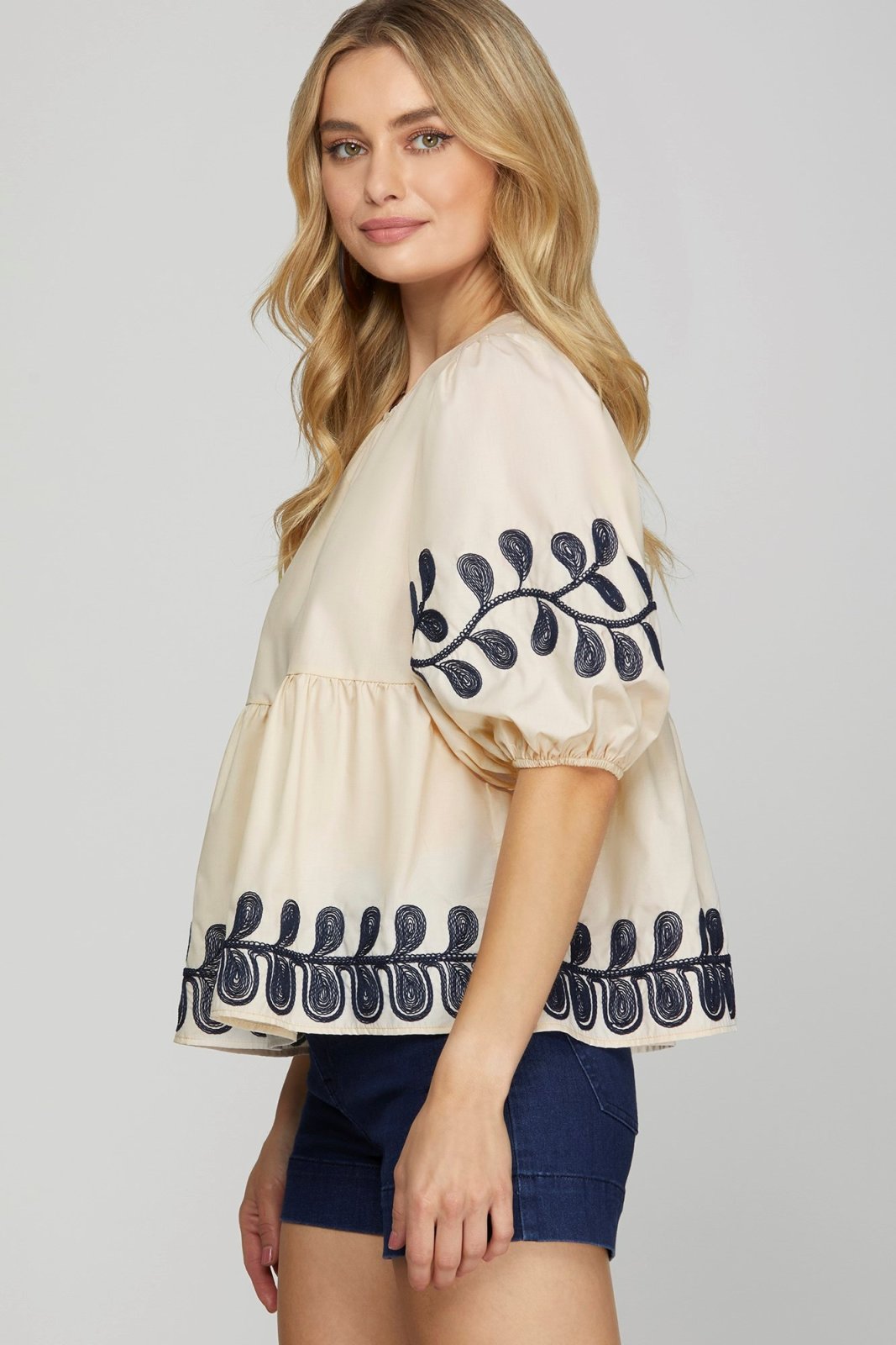 Embroidered light taupe top from a coastal boutique, perfect for tropical vacations and stylish women's fashion.