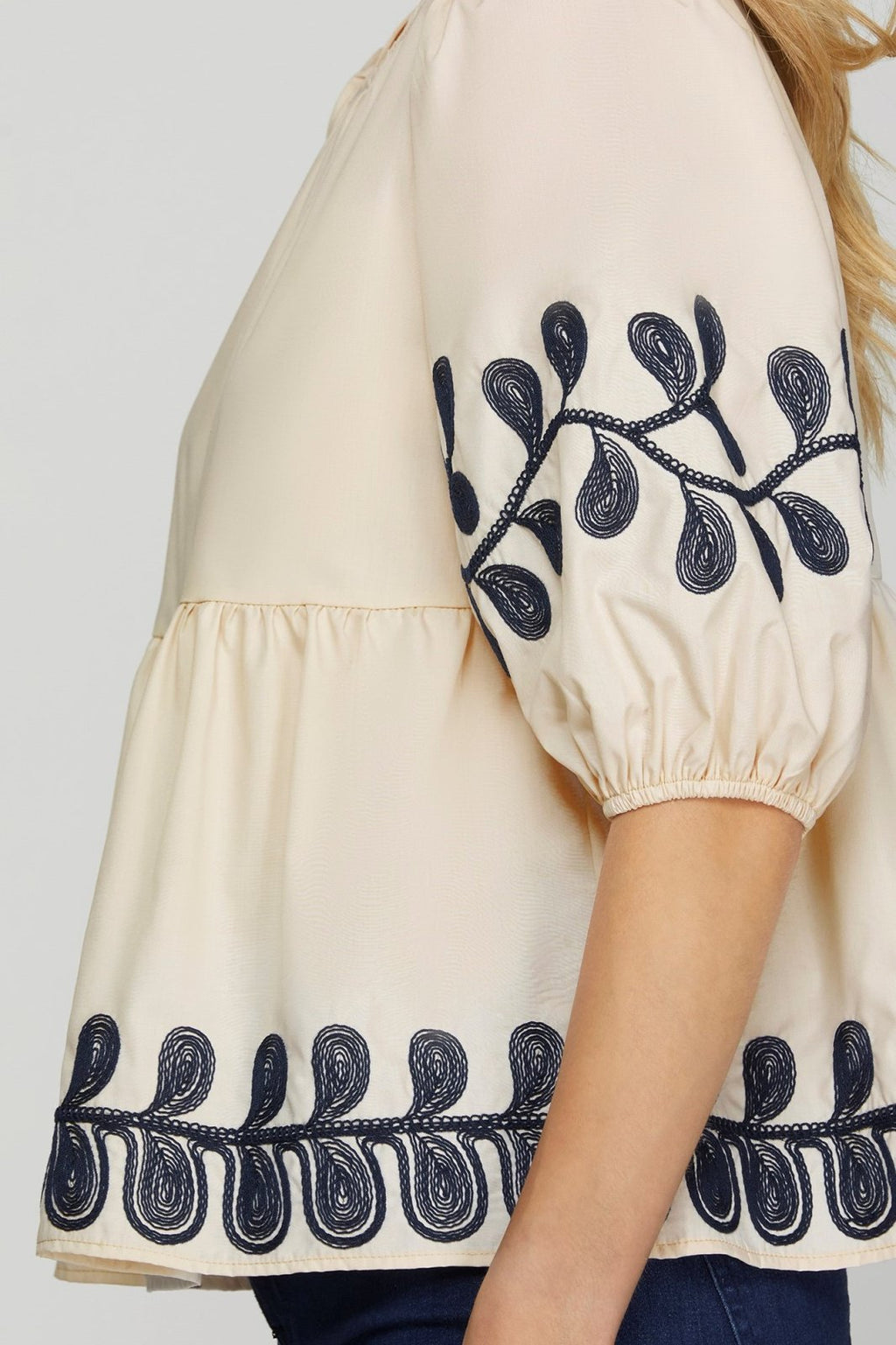 Embroidered light taupe top with navy floral design, perfect for coastal boutique clothing and stylish tops for women.