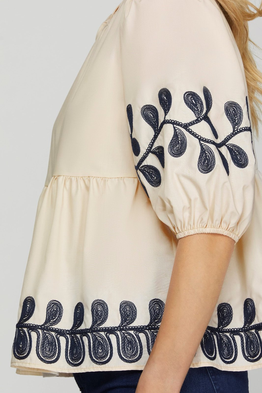 Embroidered light taupe top with navy floral design, perfect for coastal boutique clothing and stylish tops for women.