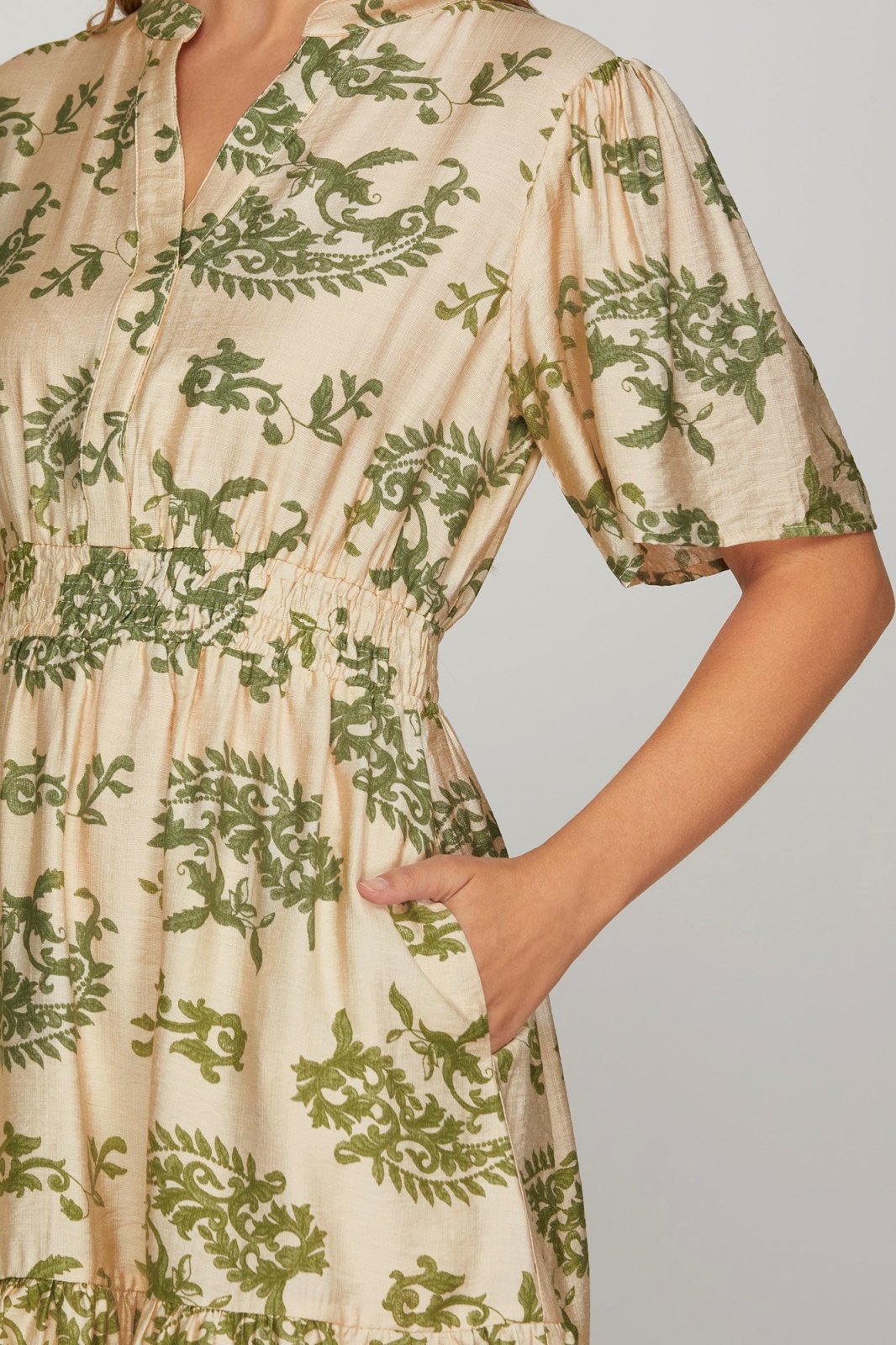 Sage green floral bell sleeve dress with functional pockets, perfect for beach outings and curated women's fashion.