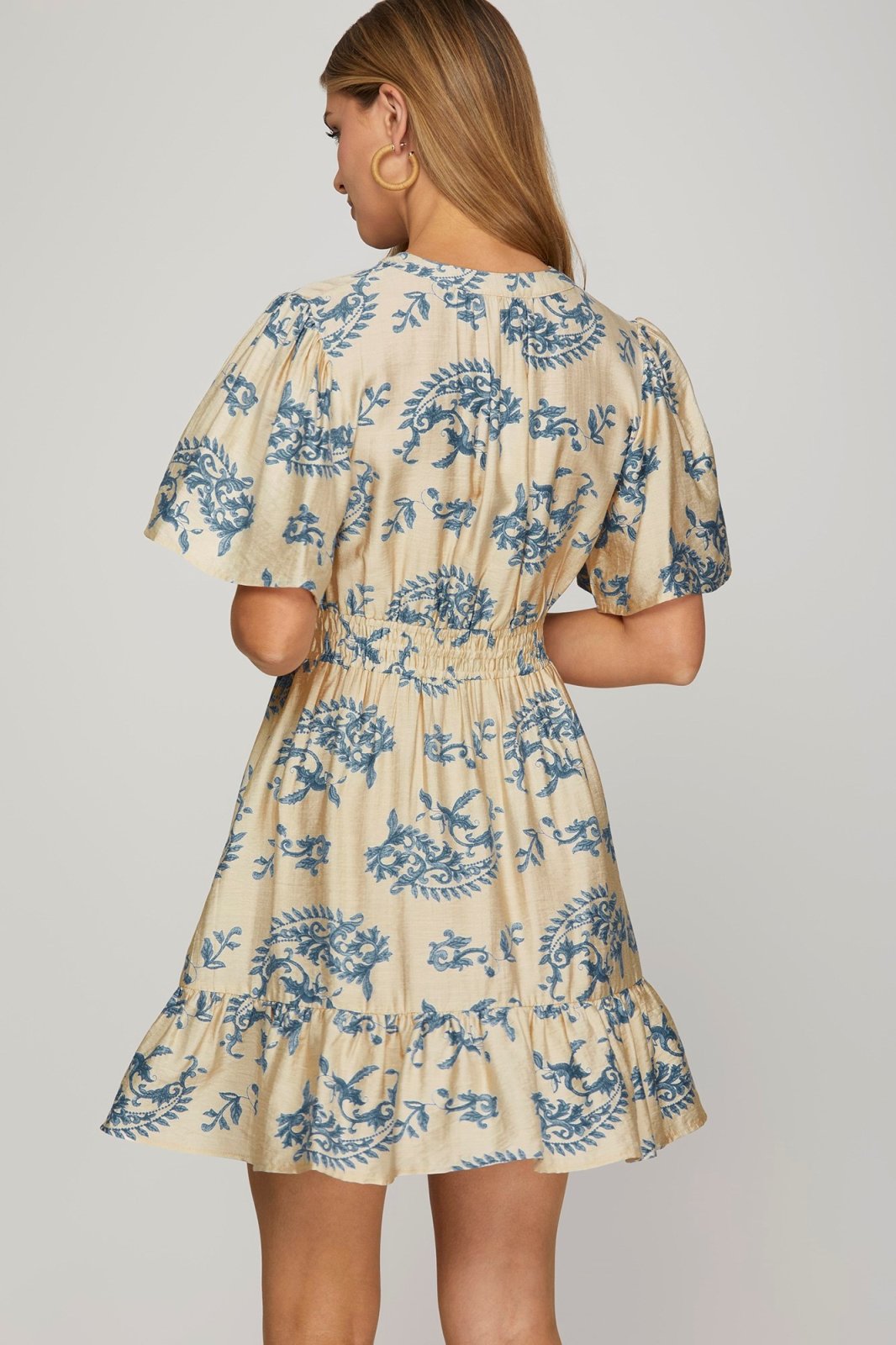 Cream mini dress with blue print, featuring a cinched waist and bell sleeves, perfect for coastal boutique clothing.
