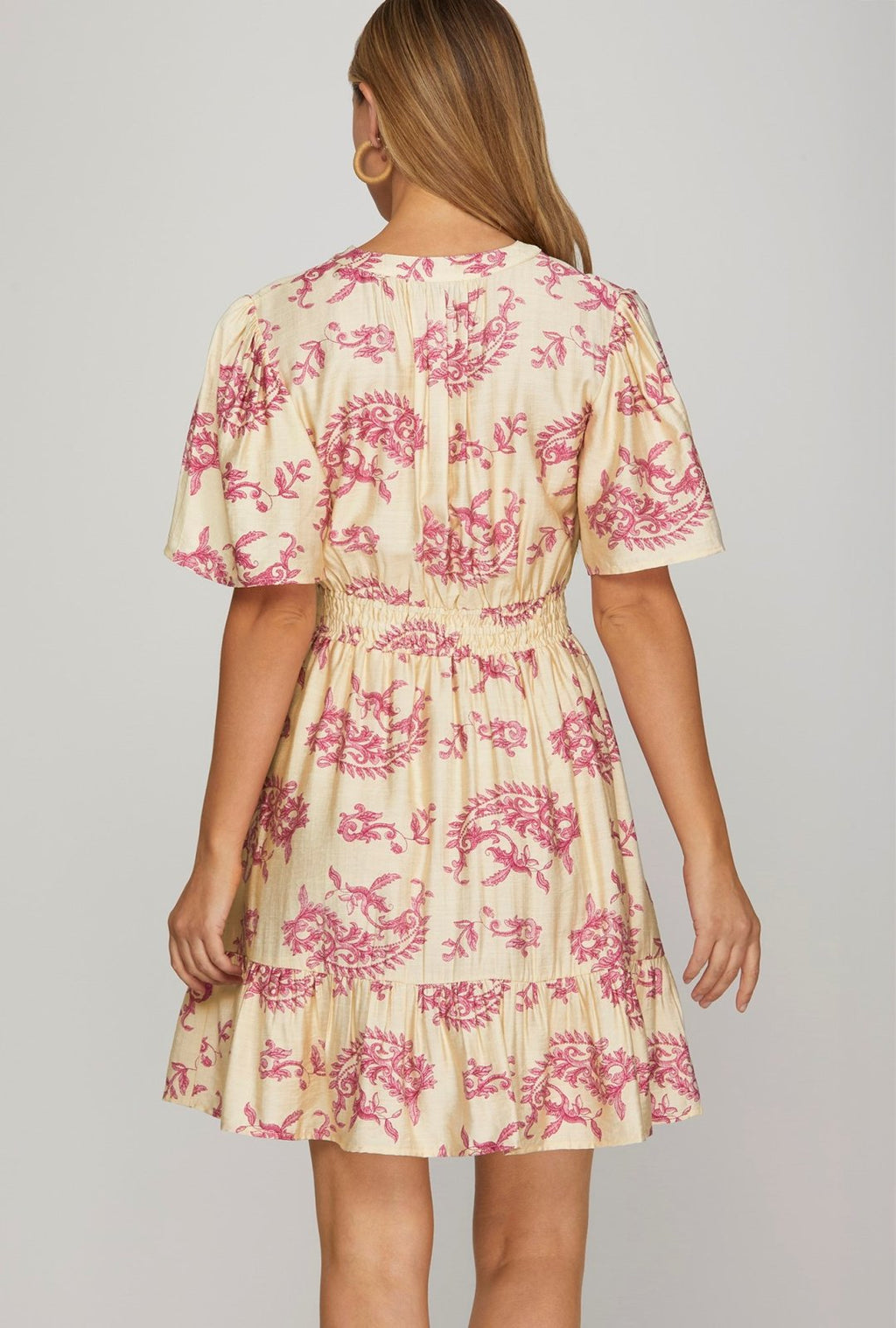 Back view of Aria Dress featuring floral pattern and ruffle hem, perfect for coastal boutique clothing in Port Aransas.