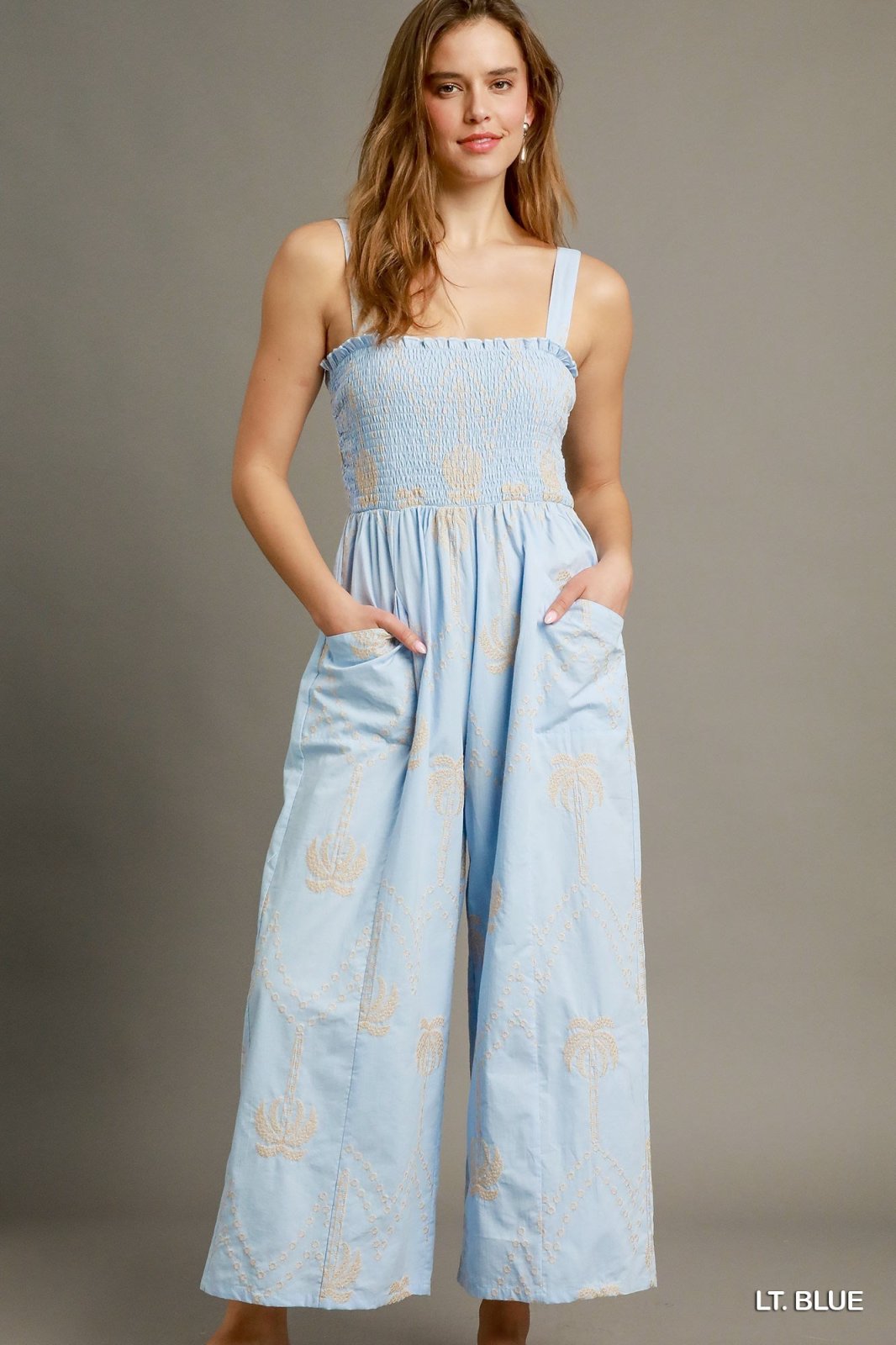 Light blue boho smocked wide-leg jumpsuit for coastal boutique clothing, perfect for tropical vacation dresses and casual outings.
