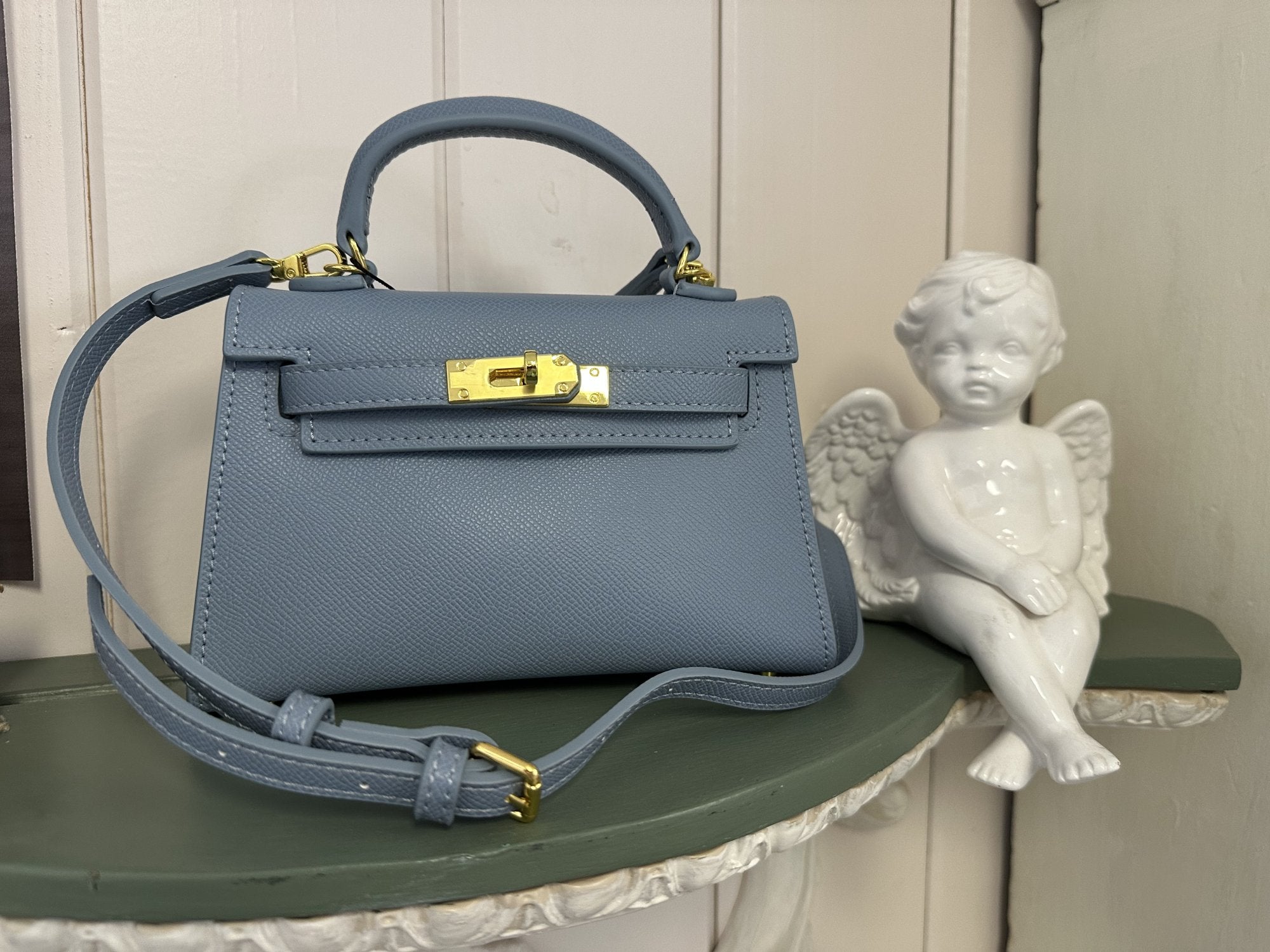 Melania Bag in blue with gold accents, perfect for coastal boutique clothing and stylish outfits.