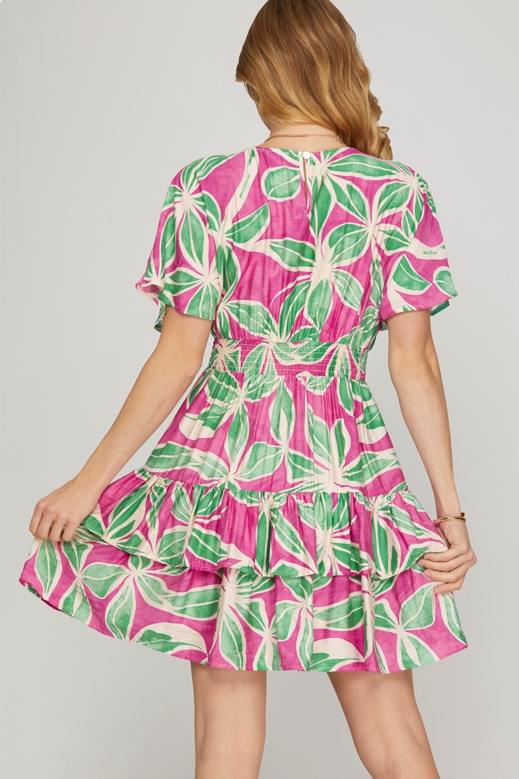 Dreamy pink and green floral mini dress from a coastal boutique, perfect for spring parties and tropical vacations.