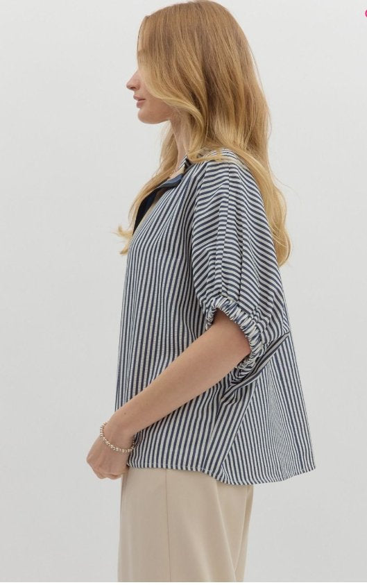 Side view of the Liz Top, a navy striped dolman top with elastic sleeve bands, perfect for trendy coastal style.