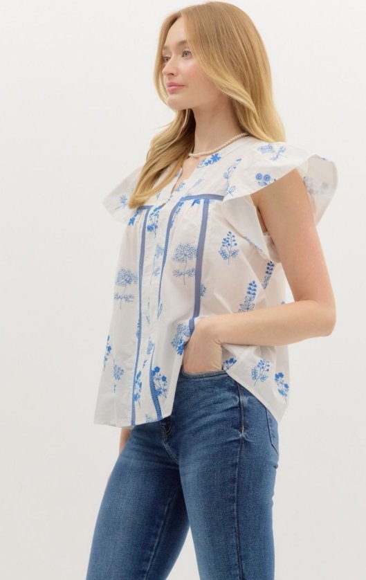 Scarlet Top in Blue from Raggdoll Boutique, featuring floral print and flutter sleeves for trendy coastal style.