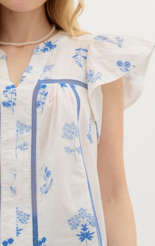 Scarlet Top in Blue featuring blue floral print and flutter sleeves, perfect for summer outfits Texas.