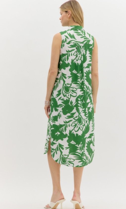 Back view of the Lucia Dress featuring a vibrant green tropical print, perfect for trendy coastal style.