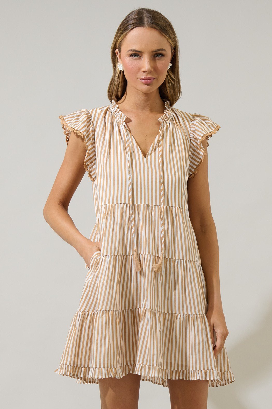Flirty taupe striped mini dress with ruffle sleeves, perfect for summer from a Port Aransas boutique.