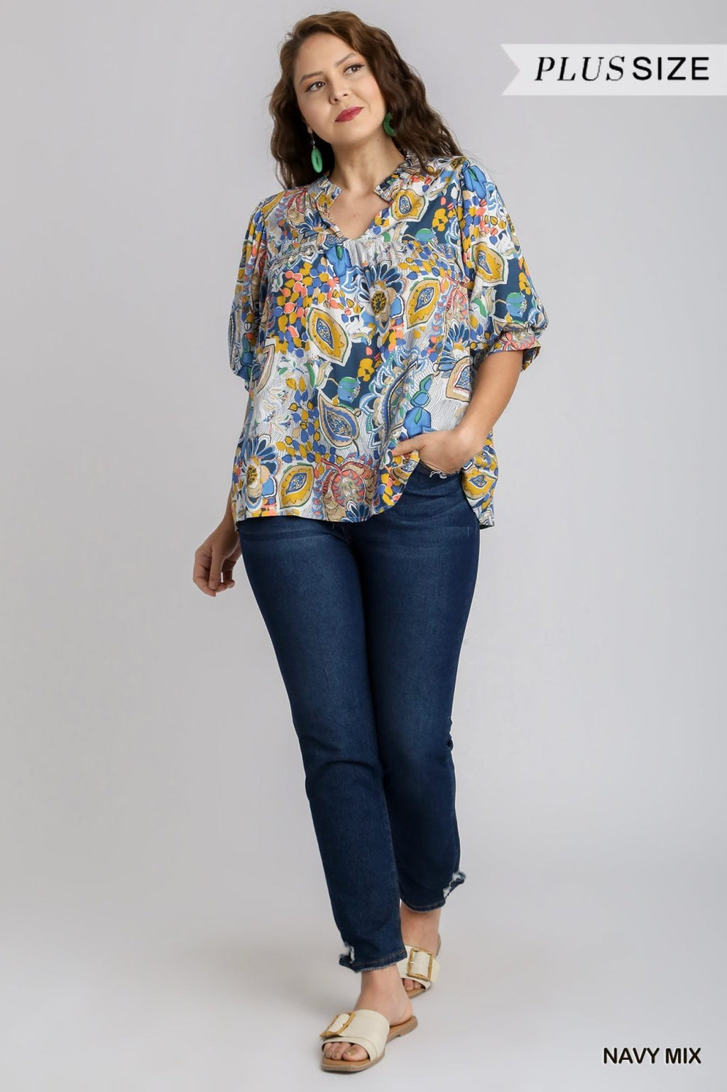 Plus size woman in floral blue multi-top and dark jeans, perfect for coastal boutique clothing and stylish tops for women.