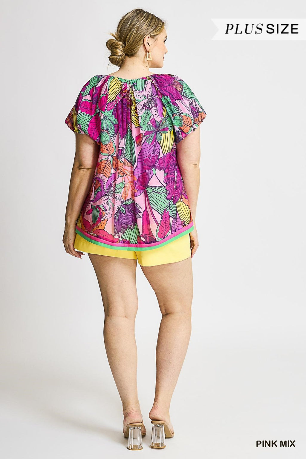 Plus size Maggie Top with vibrant floral print, perfect for coastal boutique clothing and tropical vacation vibes.