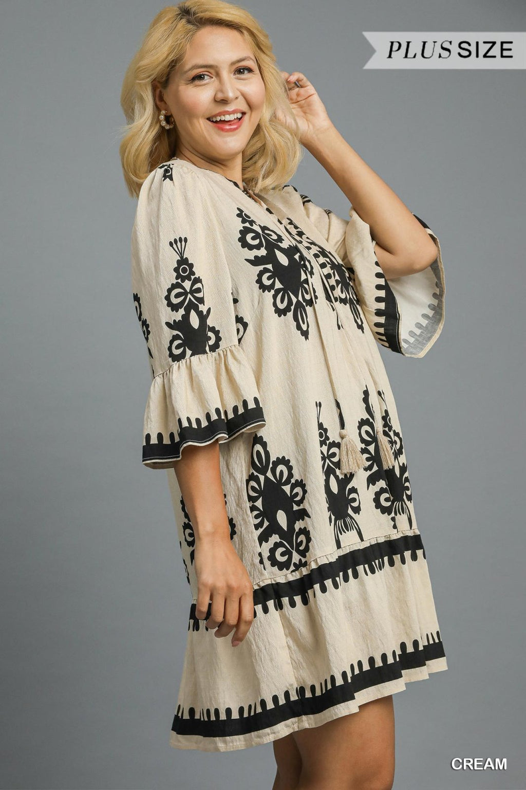 Chic cream plus size mini dress with black border print, perfect for coastal boutique clothing and tropical vacation dresses.