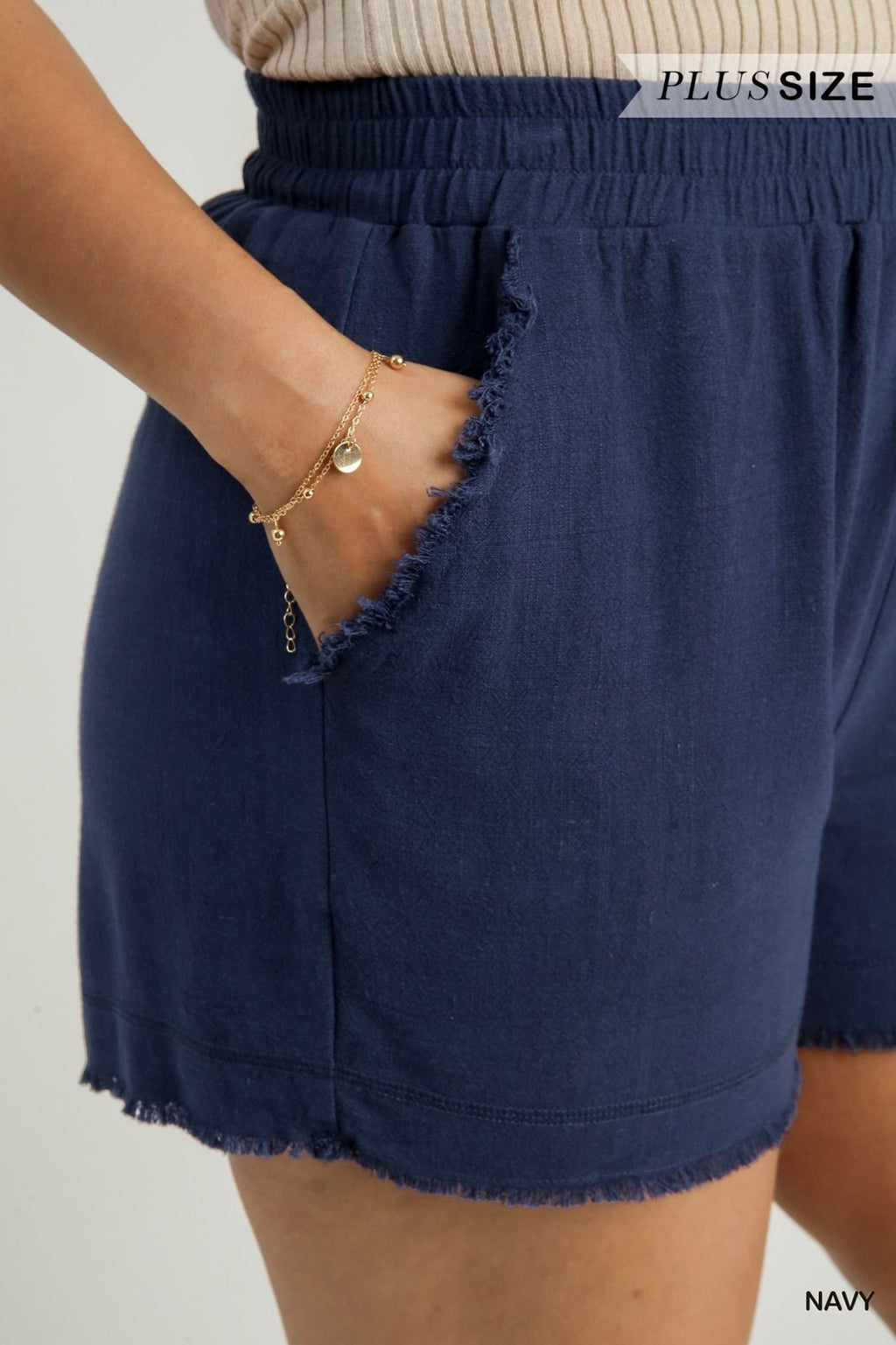 Navy frayed hem shorts with elastic waistband, perfect for summer from a coastal boutique clothing line.