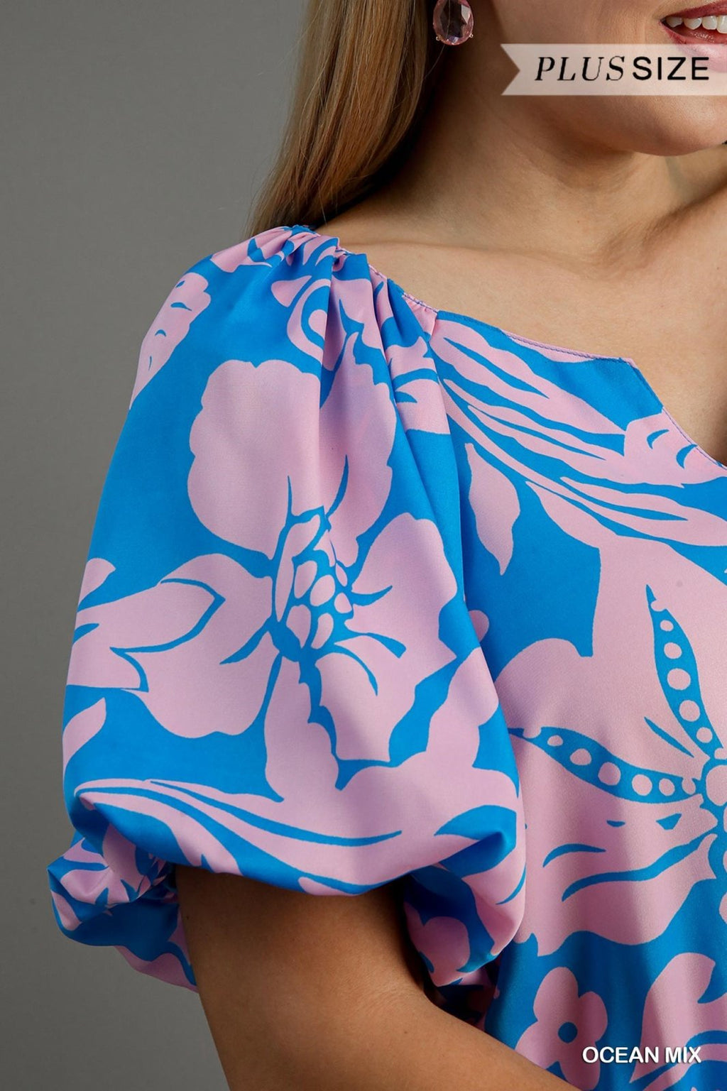 Stylish plus size floral ocean top featuring bright colors, perfect for coastal boutique clothing and tropical vacation dresses.