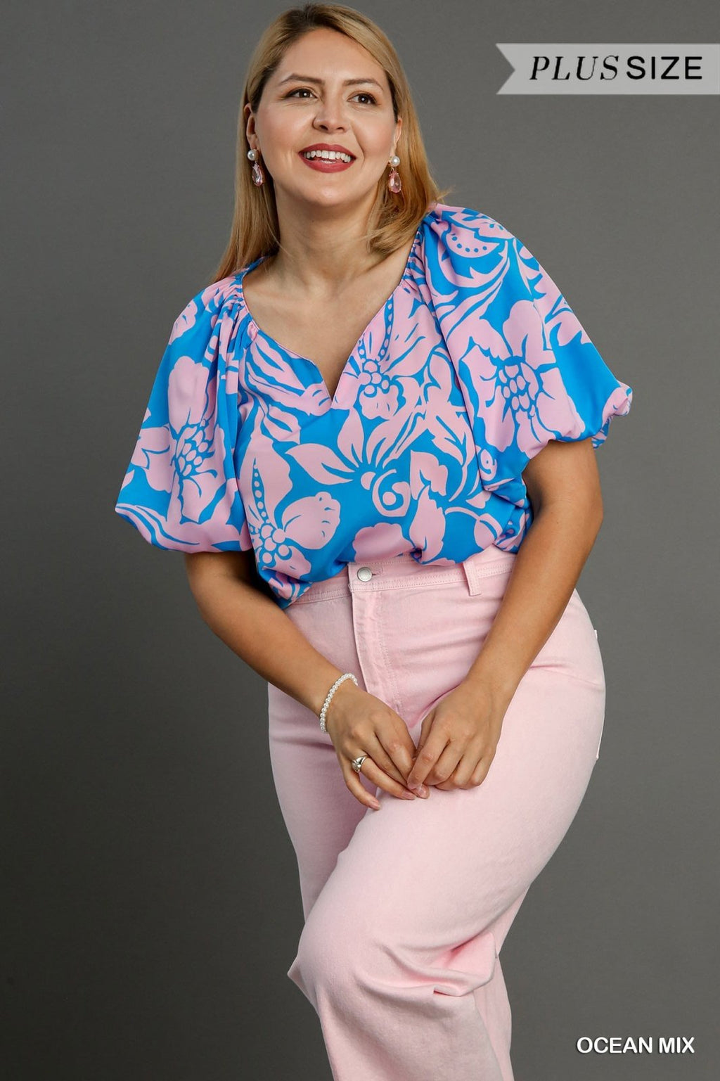 Stylish plus size ocean top in floral design, perfect for coastal boutique clothing and tropical vacation looks.