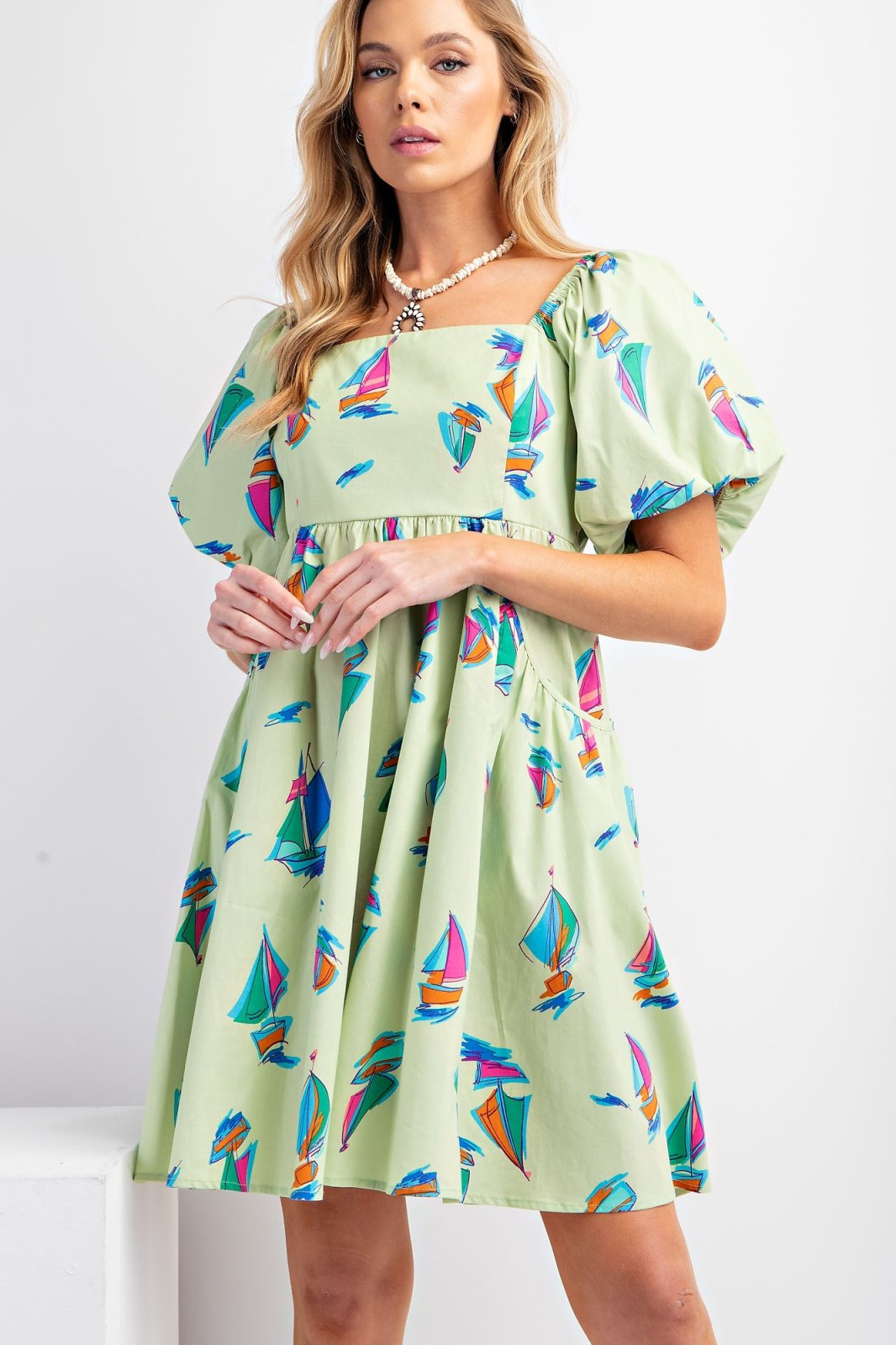 Cali Dress featuring playful sailboat prints, perfect for coastal boutique clothing and tropical vacation looks.