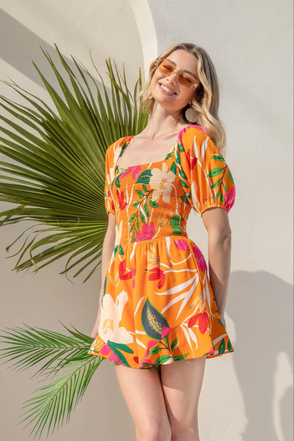 Model wearing Kat Romper from Raggdoll Boutique, showcasing trendy coastal style in summer outfit.