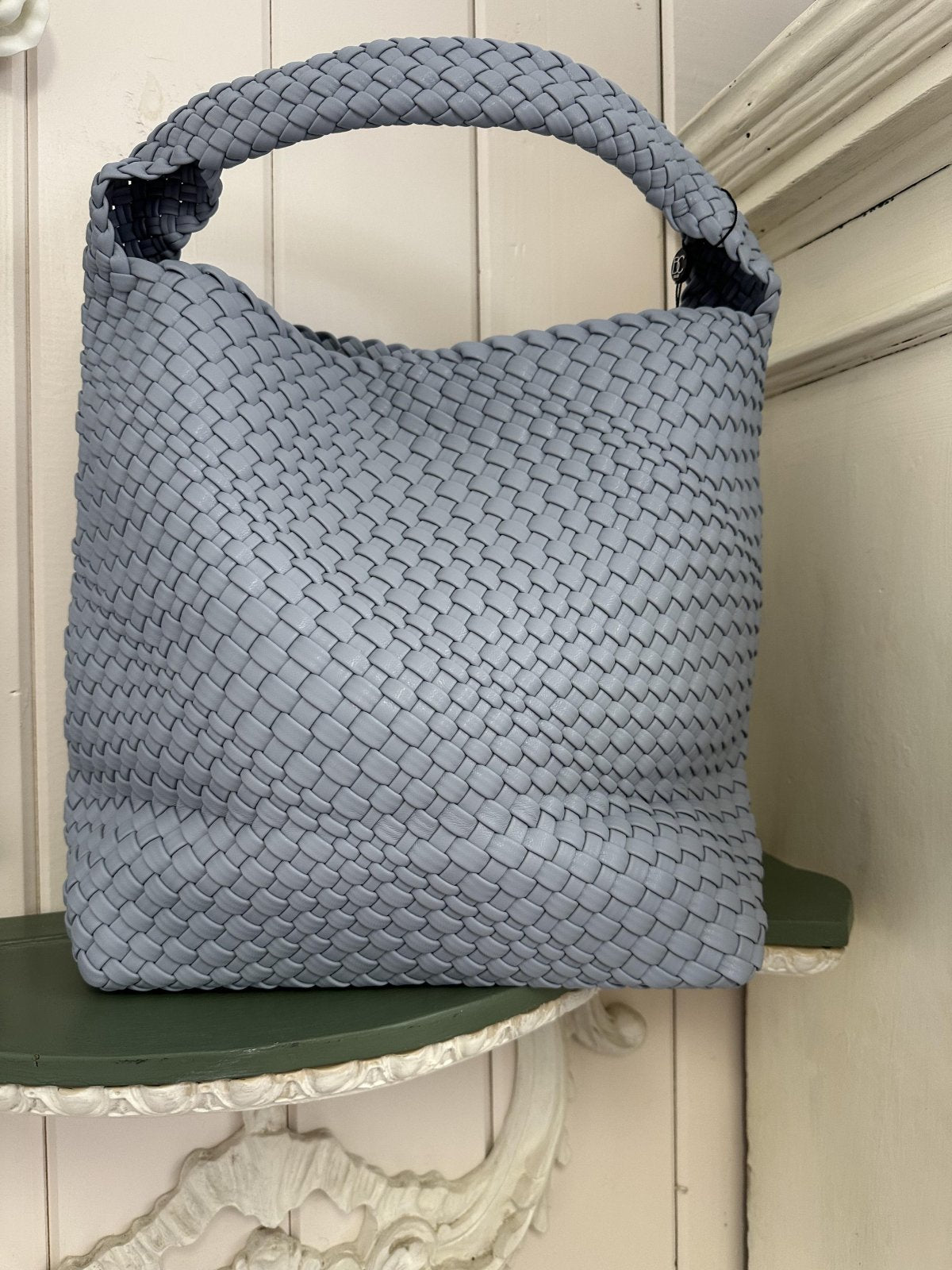 Light blue woven medium tote bag, perfect for beach days and casual outings. A stylish accessory from a Port Aransas boutique.