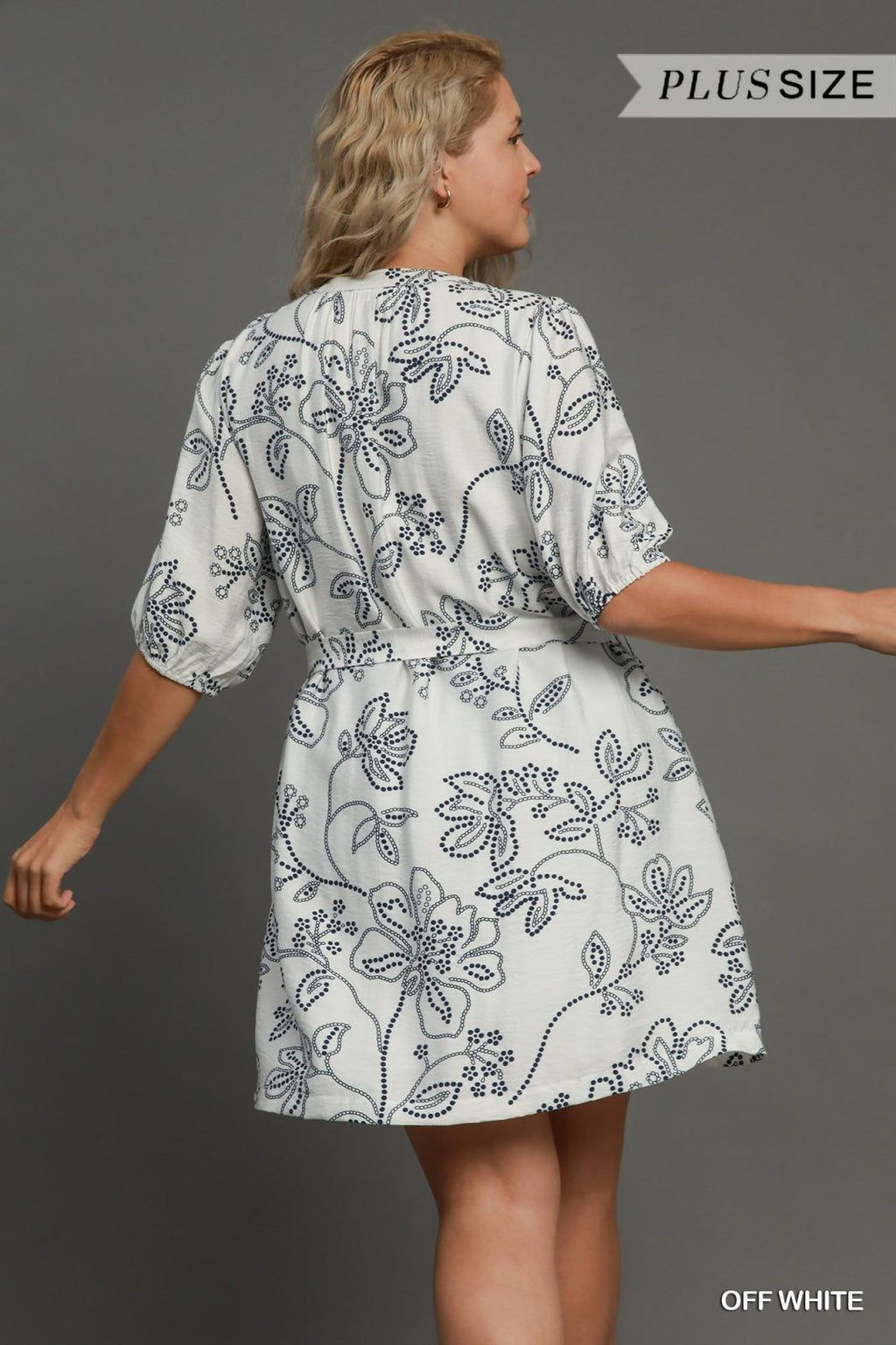 Stylish off-white plus size dress with floral prints, perfect for coastal boutique clothing and tropical vacations.