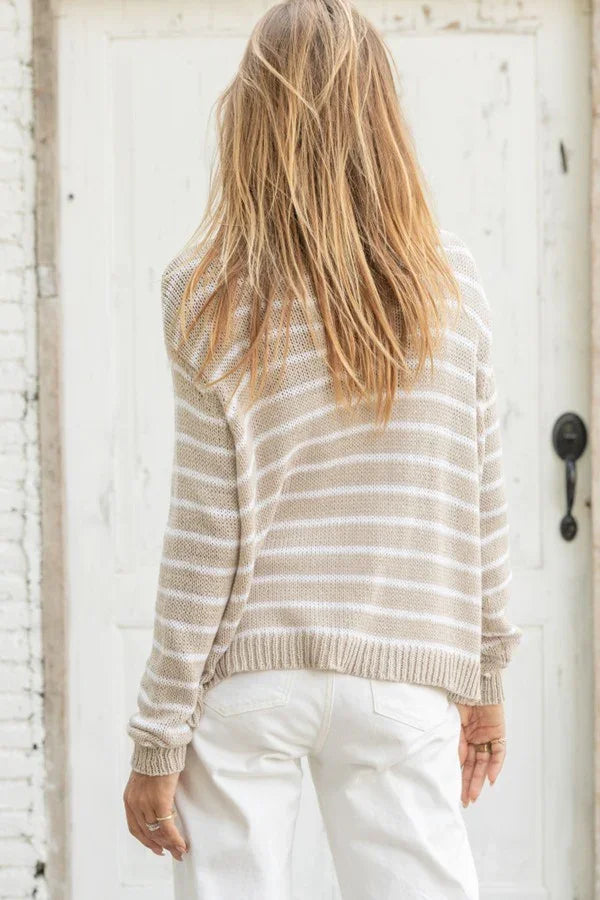 Woman wearing a khaki/peach striped crew sweater from Wooden Ships, showcasing stylish coastal boutique clothing.
