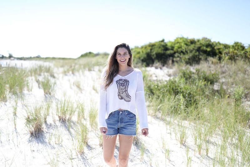 Model wearing WS Wooden Ships Boots Sweater-Breaker White, perfect for coastal boutique clothing and tropical vacations.