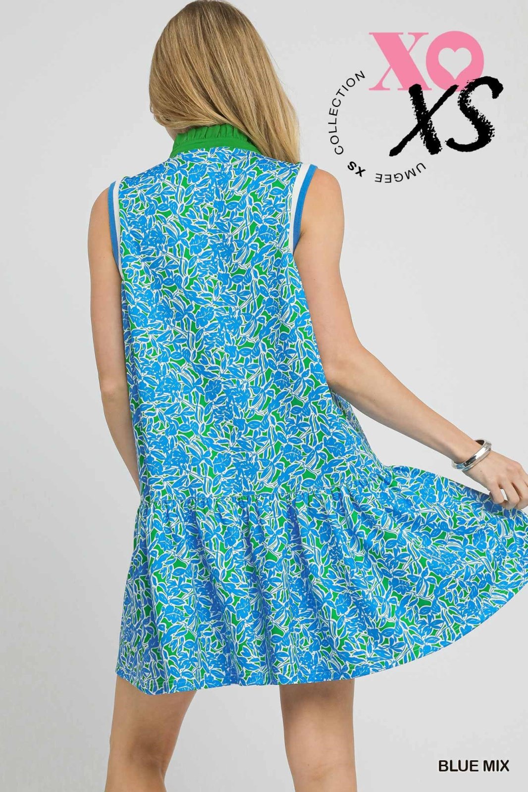 Back view of a blue and green leaf print sleeveless dress, perfect for coastal boutique clothing and beach dresses.