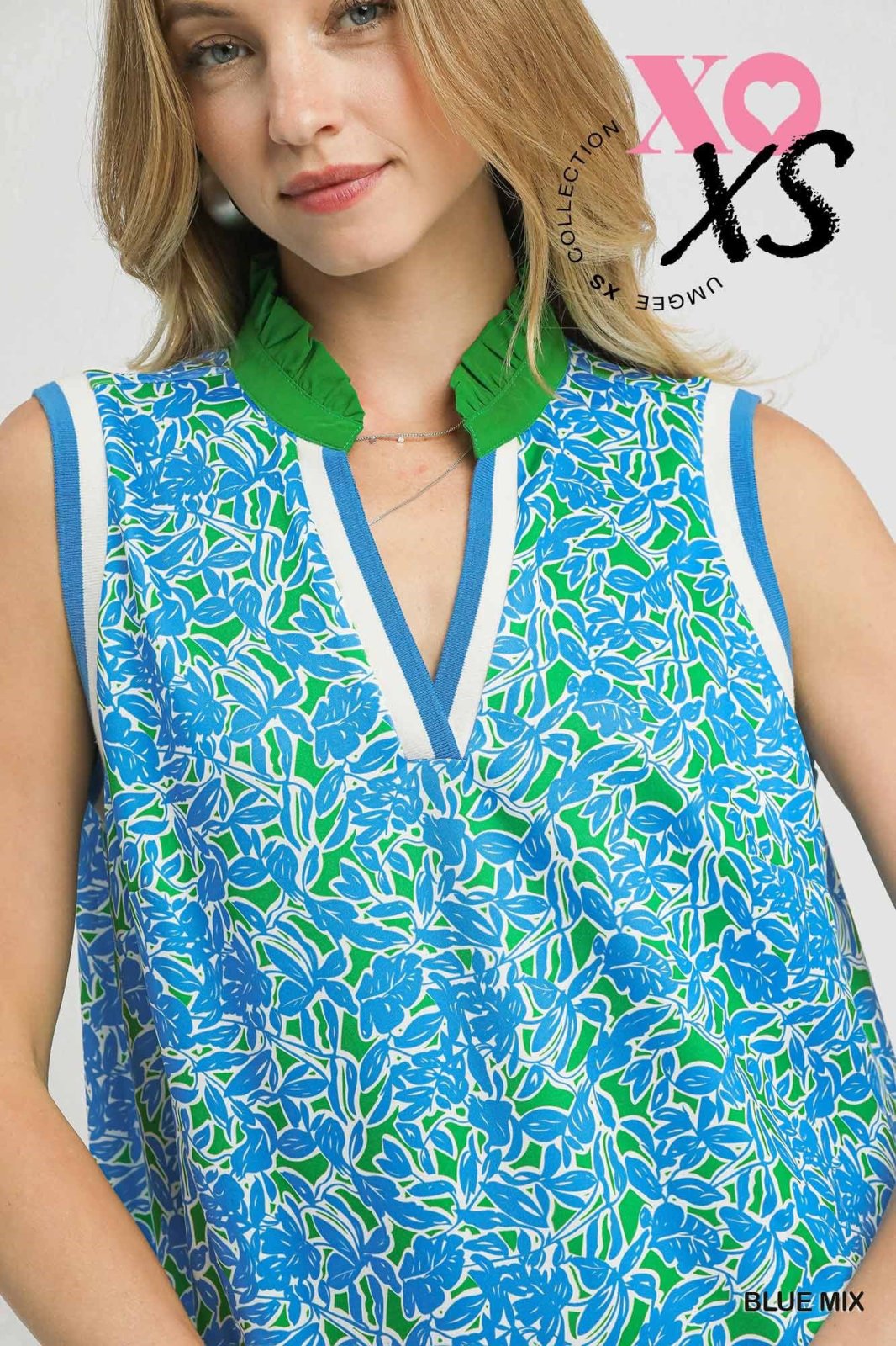 Stylish blue and green sleeveless dress from coastal boutique, featuring a mock collar, perfect for tropical vacations.