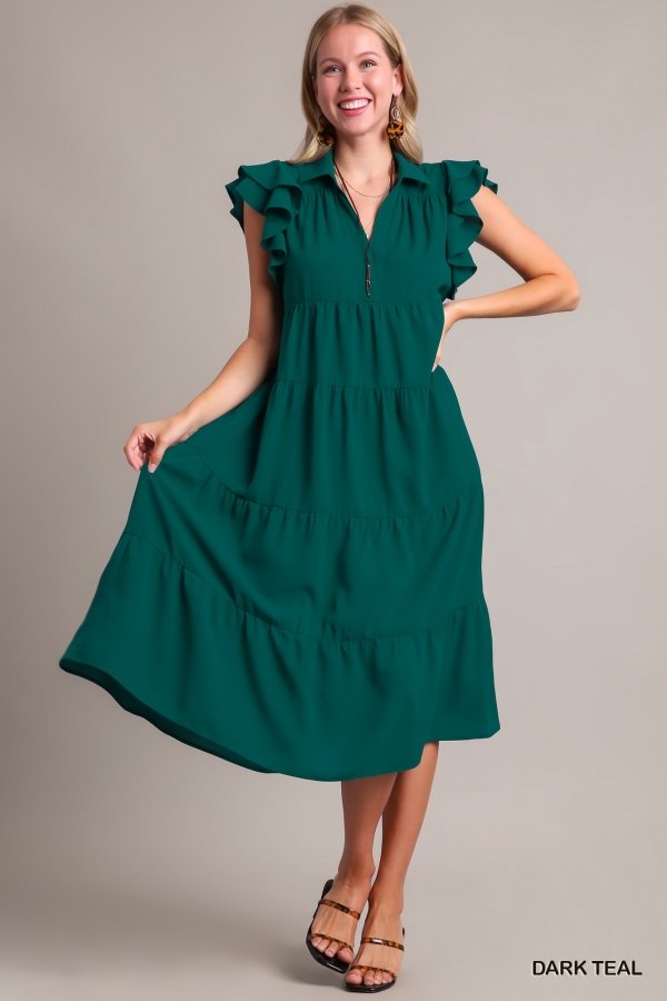 Dark teal dress with ruffles, perfect for coastal boutique clothing and tropical vacations. Ideal for stylish women and beach outings.