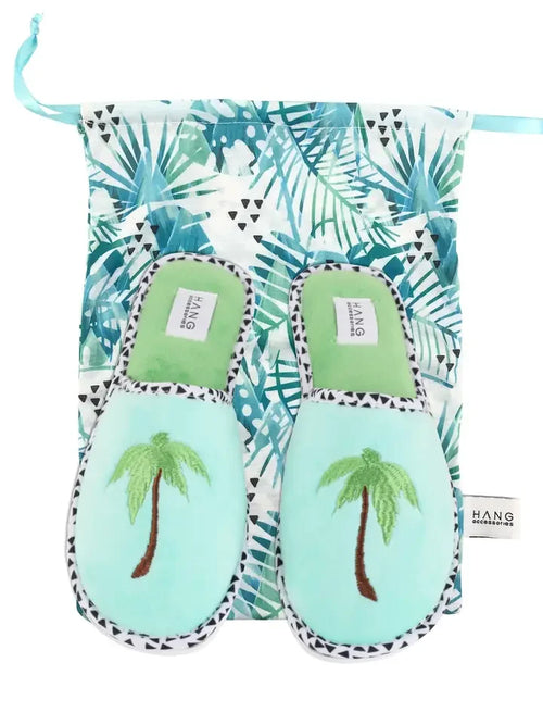 Tropical palm tree slippers in a decorative bag, perfect for beachwear and coastal boutique clothing collection.