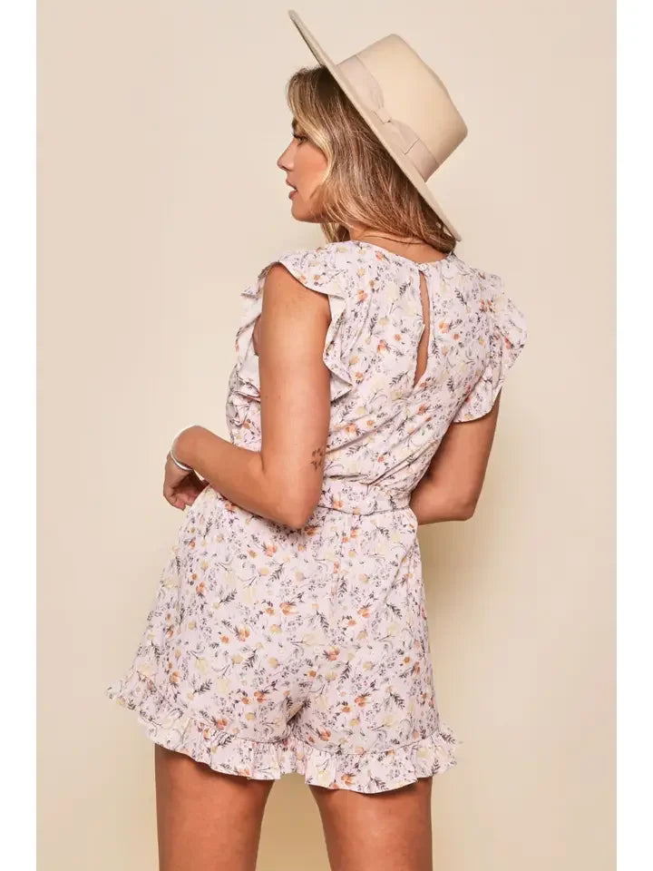 Darcy Romper worn with a stylish hat, showcasing floral print, perfect for summer outfits Texas.