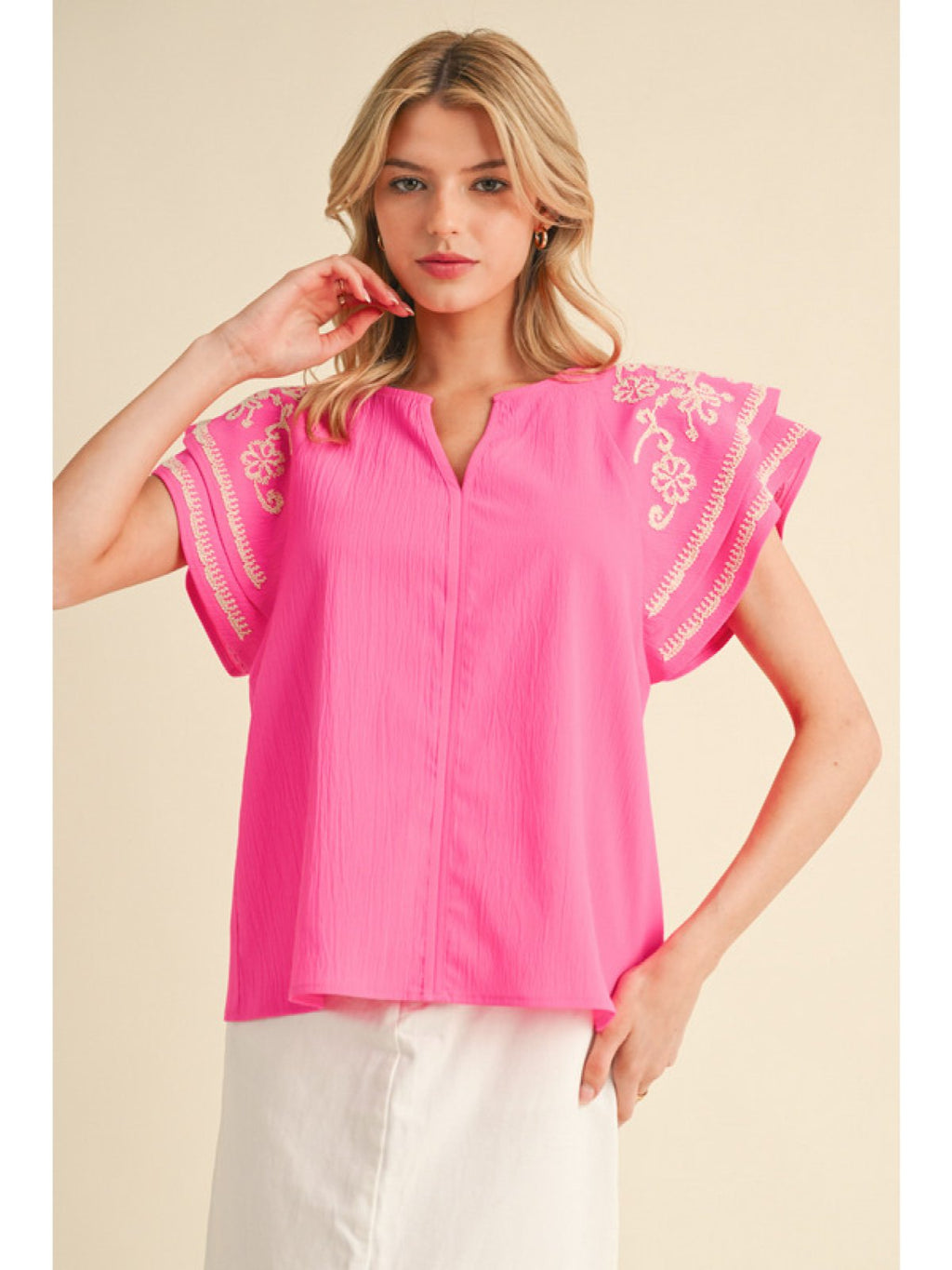 Hot pink top with elegant white floral embroidery, perfect for coastal boutique clothing and women's summer fashion.