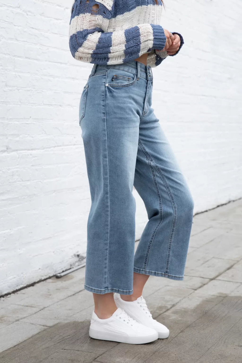 JUDY BLUE HW DOUBLE WB CROP WIDE JEAN styled with a cozy sweater and trendy sneakers at Raggdoll Boutique.